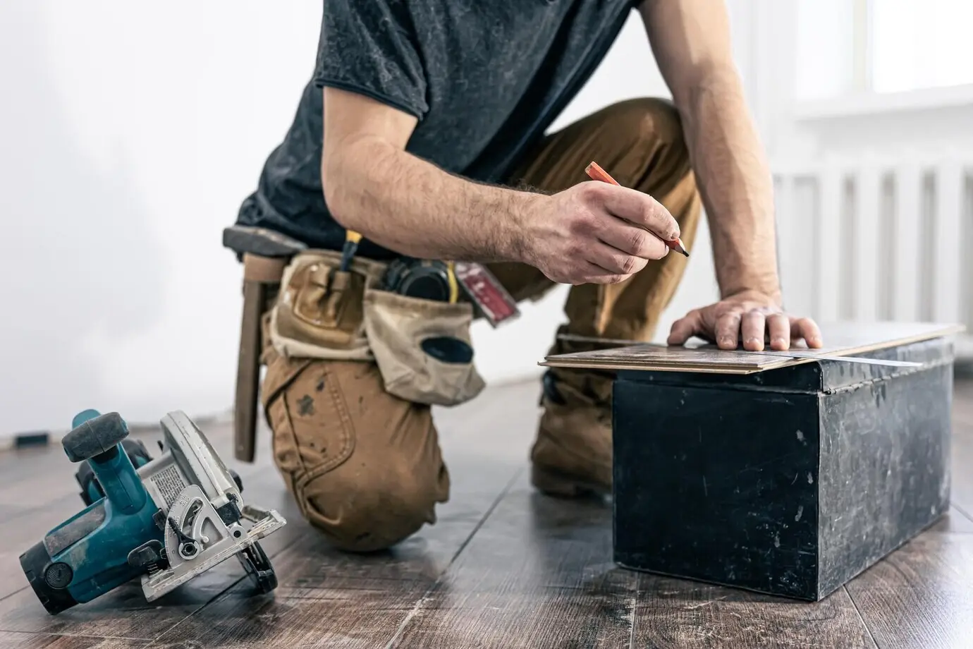 A carpenter using a circular saw for wood.