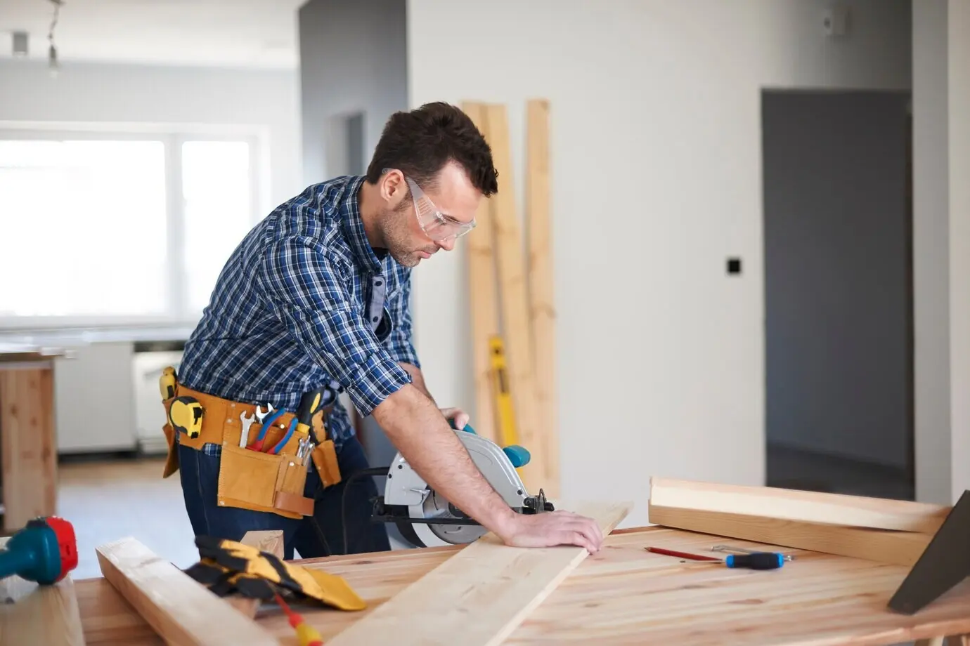 A carpenter at work in a house.