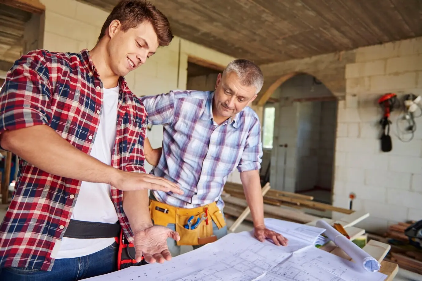 Two carpenters collaborating in construction.